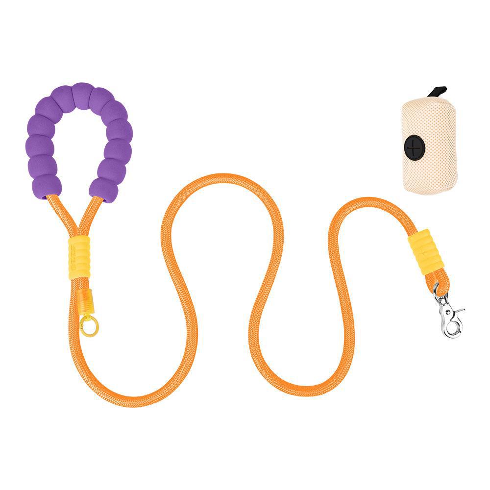 Multifunctional dog training leash in orange and purple with attached yellow hook and adjacent folded white poop bag with black handle.