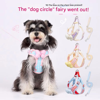 Korean style plaids bow dog cat chest harness with leash in pink and blue checkered design on a black and white coated dog.